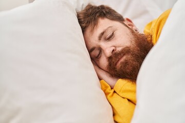 Wall Mural - Young redhead man lying on bed sleeping at bedroom