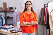 Young Beautiful Hispanic Woman Tailor Smiling Confident Standing With Arms Crossed Gesture At Tailor Shop