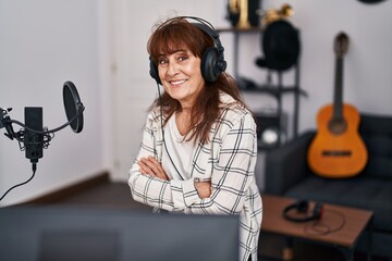 Sticker - Middle age woman musician smiling confident with arms crossed gesture at music studio