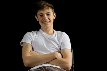 Portrait of a 17 year old boy on a black background