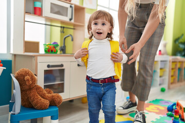 Adorable hispanic girl student smiling confident standing at kindergarten