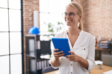 Canvas Print - Young blonde woman business worker using touchpad at office