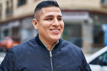 Poster - Young latin man smiling confident looking to the side at street