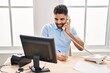 © Krakenimages.com - Young hispanic man business worker using talking on telephone at office