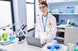 © Krakenimages.com - Young caucasian woman scientist smiling confident using laptop at laboratory