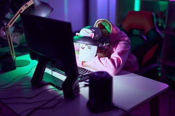 Canvas Print - Young blonde woman streamer stressed using computer and headphones at gaming room