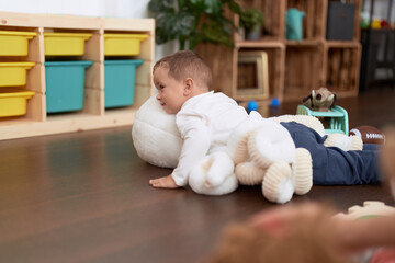 Poster - Adorable toddler playing with dolls sitting on floor at home