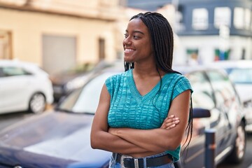 Sticker - African american woman smiling confident standing with arms crossed gesture at street