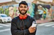 © Krakenimages.com - Young arab man smiling confident holding graffiti spray at street