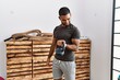 © Krakenimages.com - Young arab man smiling confident training with kettlebell at sport center
