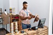 © Krakenimages.com - Young arab man smiling confident working at clothing store
