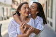 © Krakenimages.com - Two women mother and daughter hugging each other kissing at street