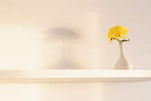 Yellow Chrysanthemum In Vase On White Shelf On White Background