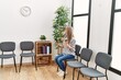 © Krakenimages.com - Young chinese woman using smartphone sitting on chair at waiting room