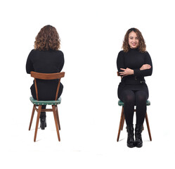 Wall Mural - Front and back view of the same woman sitting on the chair in a black dress on a white background.