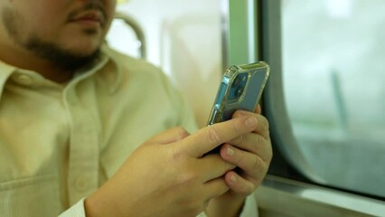 Canvas Print - A man in a commuter train subway metro traveling and uses the smartphone happy tourist travel by train  Freedom trip on vacation time holiday weekend