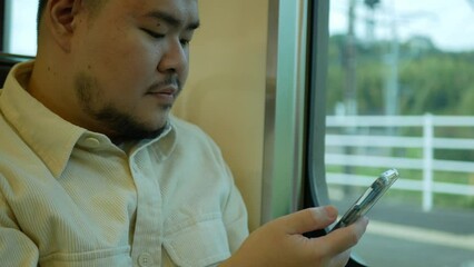 Canvas Print - A man in a commuter train subway metro traveling and uses the smartphone happy tourist travel by train  Freedom trip on vacation time holiday weekend