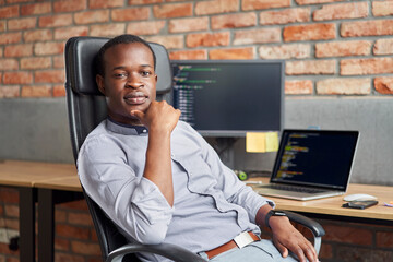 Wall Mural - Portrait of Freelance Programmer at His Desk in a Small Business Office