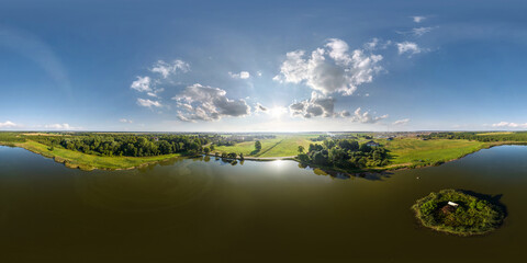Wall Mural - 360 hdri panorama aerial view over lake with island in equirectangular seamless spherical projection with zenith and nadir,  ready for use as sky replacement in drone 360 panoramas or VR content