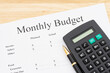 Calculating your monthly budget with a calculator on a desk