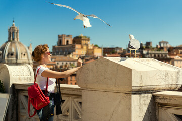 Wall Mural - Girl tourist looks at Rome from Capitoline Hill top, Italy, Europe