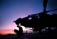 Apache Pilot Say His Prayers Prior To Mission.