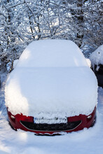 A Car Completely Covered With Thick Snow After A Snowstorm.