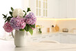 © New Africa - Bouquet with beautiful hydrangea flowers on white marble table. Space for text