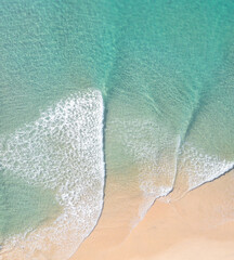 Wall Mural - Aerial view of stunning waves crushing near sand banks in a stunning blue water