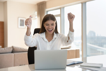 Get career advance and promotion, receive great commercial offer, moment of internet lottery win, triumph. Young cheery woman sit at desk with laptop, read e-mail celebrate business success feel happy