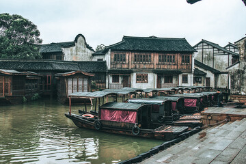 Wall Mural - Traditional chinese architectures and boats in Andufang Wharf in Wuzhen West area in cloudy days