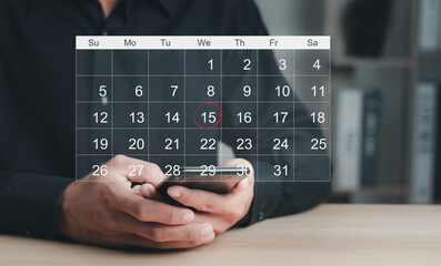 Time management concept..Businessman manages time for effective work. Calendar on the virtual screen interface. Highlight appointment reminders and meeting agenda on the calendar.