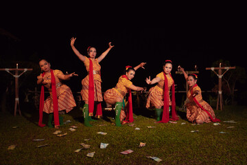 Javanese dancers with beautiful makeup and traditional costume while dancing the traditional dance on the stage