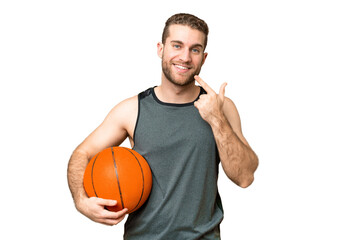 Wall Mural - Handsome young man playing basketball over isolated chroma key background giving a thumbs up gesture