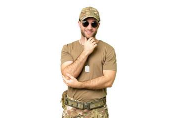 Military with dog tag over isolated chroma key background with glasses and smiling