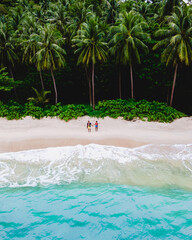 Wall Mural - Drone aerial view at couple on the beach at Freedom beach in Phuket Thailand during vacation, top view at tropical beach with people on the beach