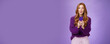 Impressed speechless cute redhead female actor receiving awesome surprising message on mobile phone open mouth from amazement and raising eyebrows astonished, posing over purple wall