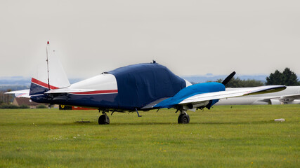 Wall Mural - Twin engined classic light aircraft. Dating from the 1950's with winter protection for canopy and engines.