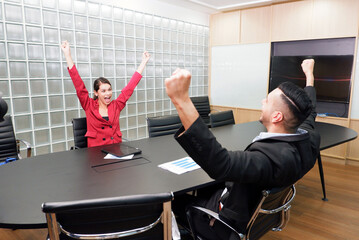 Wall Mural - Executives and female employees raise their hands and smile.