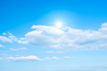 Canvas Print - white clouds and sun with sunlight on blue sky.