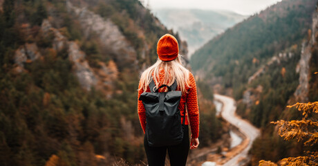 Woman hiker sits and enjoys valley view from viewpoint. Hiker reached top of the mountain and relaxes. Slovakia, mala fatra. Adventure and travel in the mountains region