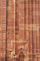 Wall Mural - Floral Motfis decoration in the wall of Qutb Minar complex at New Delhi, India. Relief carving at the old monument. Unesco heritage site at Delhi.