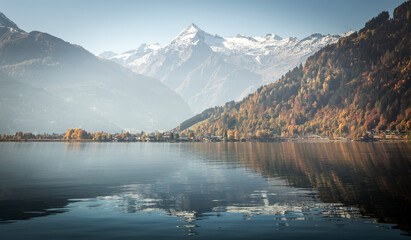 Fotobehang - Wonderful nature landscape. Impressive Autumn scenery. Zell am see Lake in front of the mount under sunlight. Amazing sunny day on the mountain lake. concept of ideal resting place. instagram filter