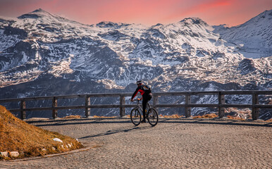 Fototapete - Amazing Nature Scenery at sunset. Mountain biking man on track Grossglockner High Alpine Road. Austria. Travel Lifestyle adventure concept. Outdoor wilderness vacations. Active recreation concept