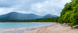 panorama of the famous conchal beach over the pacific in costa rica; paradise beach with turquoise water and green hills in the background