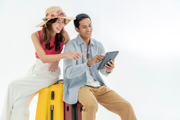 Wall Mural - Portrait of an Asian couple with their suitcases, passports and travel tickets. isolated on a white background