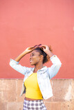 Fototapeta Tematy - Afro woman on pink background with arms up