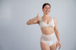 © Михаил Решетников - Woman in adult diapers smiling and showing thumbs up. Urinary incontinence problem.