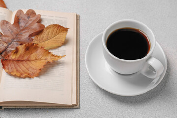 Sticker - Cup of hot drink, book and autumn leaves on light grey textured table