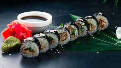 Wall Mural - Maki sushi rolls with smoked eel, cucumber, sesame seeds, soy sauce, wasabi and ginger.